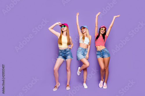 Holiday weekend rest relax free time concept. Portrait of cheerful comic girls enjoying sunlight chilling together with perfect mood isolated on bright violet background