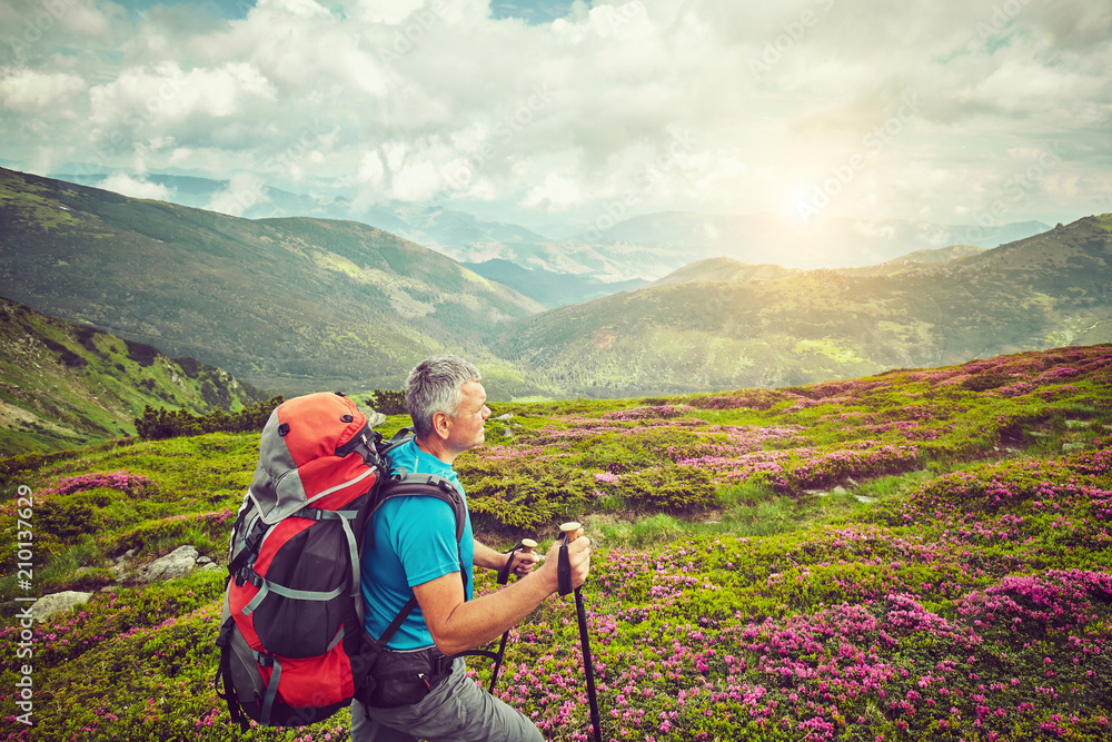 Man with red backpack enjoying landscape on cliff solo traveling healthy lifestyle concept active summer vacations Man with red backpack enjoying landscape on cliff solo traveling healthy lifestyle concept active summer vacations
