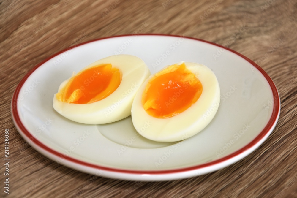 halved boiled egg on a white saucer halved boiled egg on a white saucer