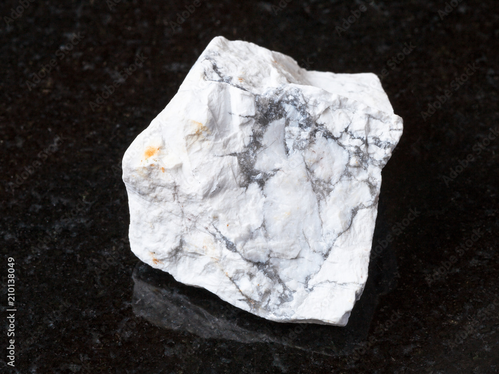 rough Howlite stone on black granite rough Howlite stone on black granite