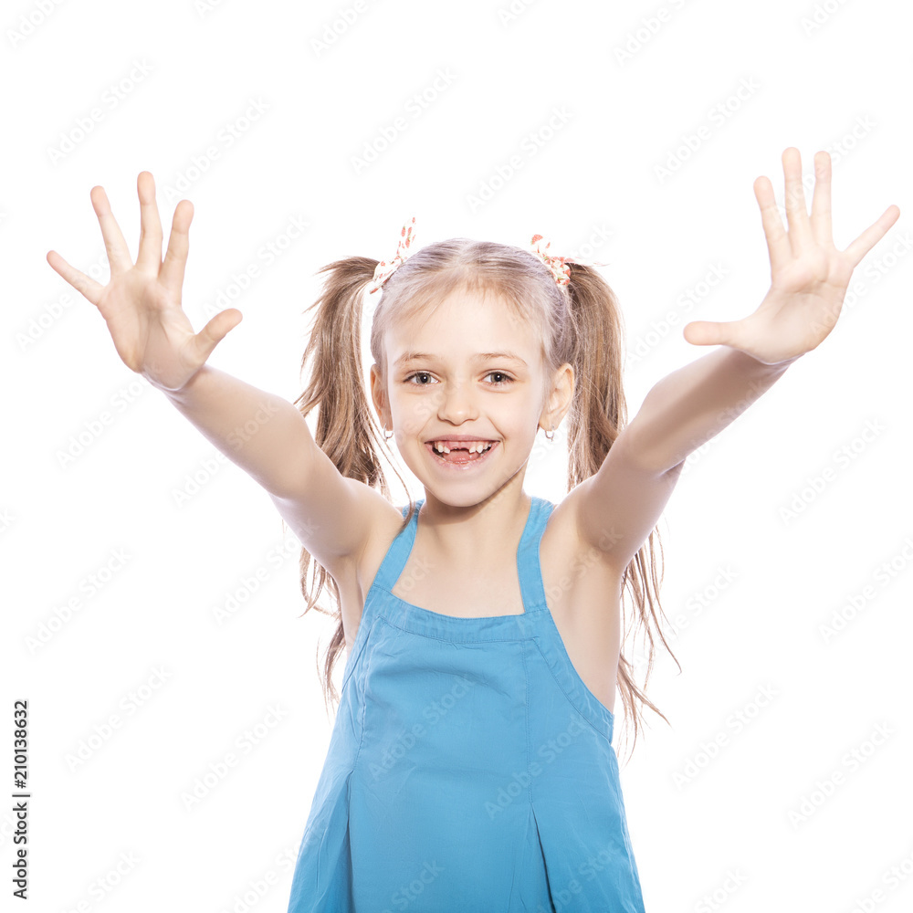 Young seven years old brunette girl in blue dress on a white isolated background. She make palms up gesture with her hands, smiling and happiness and joy emotions on her face Young seven years old brunette girl in blue dress on a white isolated background. She make palms up gesture with her hands, smiling and happiness and joy emotions on her face