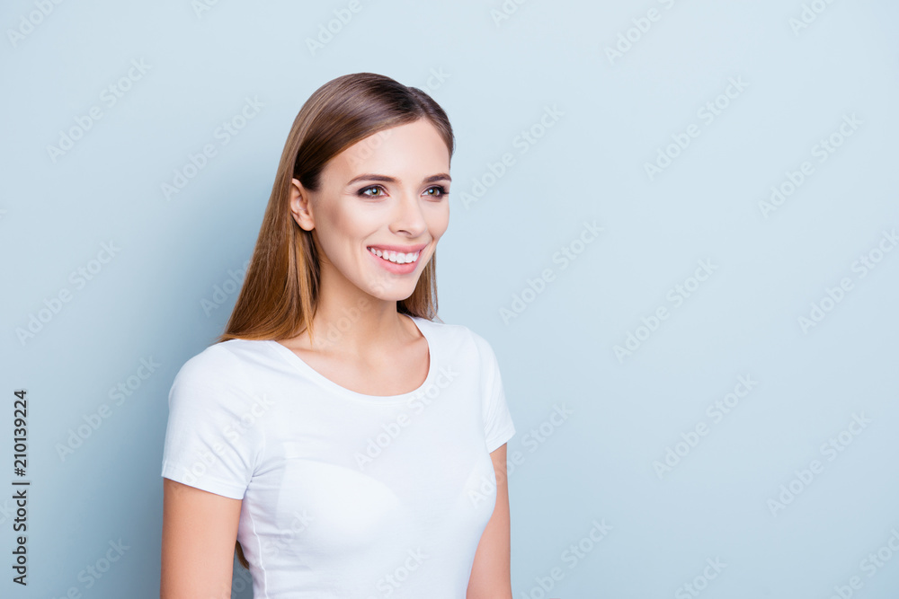 Advertisement concept. Portrait with copy space empty place of cheerful stylish brunette girl in white t-shirt isolated on grey background Advertisement concept. Portrait with copy space empty place of cheerful stylish brunette girl in white t-shirt isolated on grey background