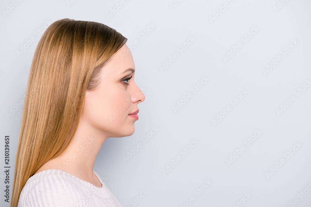 Profile portrait of serious concentrated girl isolated on grey background with copyspace empty place. Health care wellness wellbeing treatment concept Profile portrait of serious concentrated girl isolated on grey background with copyspace empty place. Health care wellness wellbeing treatment concept