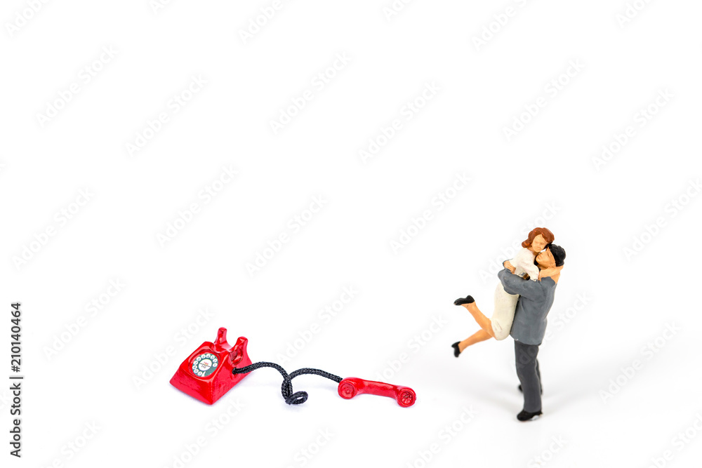 selective focus of miniature couple with phone and board isolated on white , Image for business idea concept selective focus of miniature couple with phone and board isolated on white , Image for business idea concept