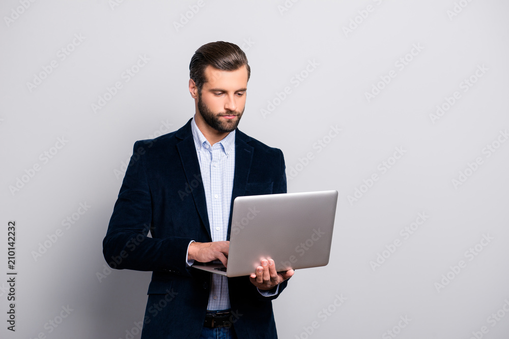 Portrait of smart clever intelligent confident handsome concentrated focused pensive busy banker looking for information news on the internet isolated on gray background copy-space Portrait of smart clever intelligent confident handsome concentrated focused pensive busy banker looking for information news on the internet isolated on gray background copy-space