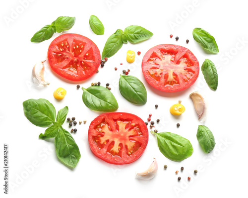 Composition with spices and tomatoes on white background