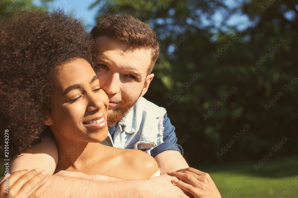 Fototapeta premium Young loving interracial couple outdoors on spring day