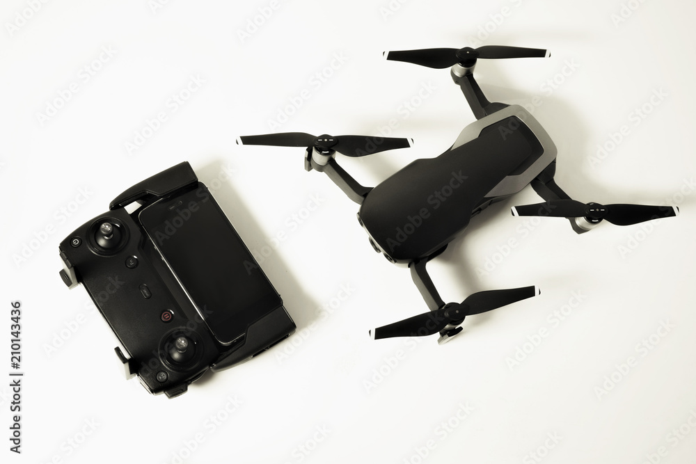 Drone with controller and smartphone on white background Drone with controller and smartphone on white background