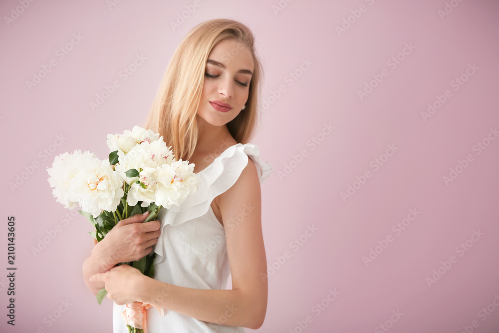 Attractive young woman with beautiful flowers on color background