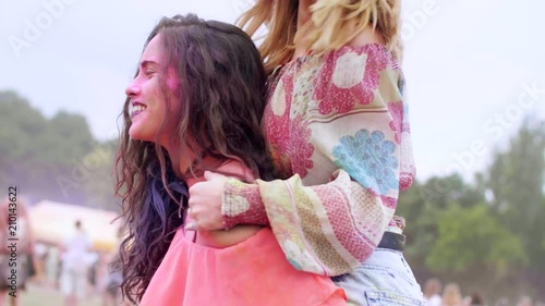 Woman carrying her friend piggyback