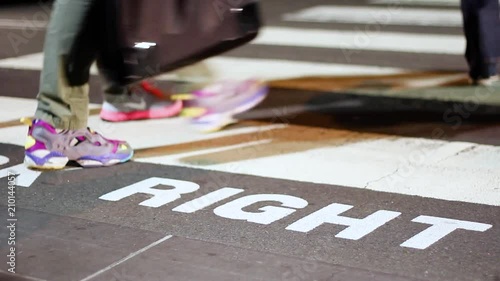 Pedestrians walking across a Sydney crosswalk in the night photo