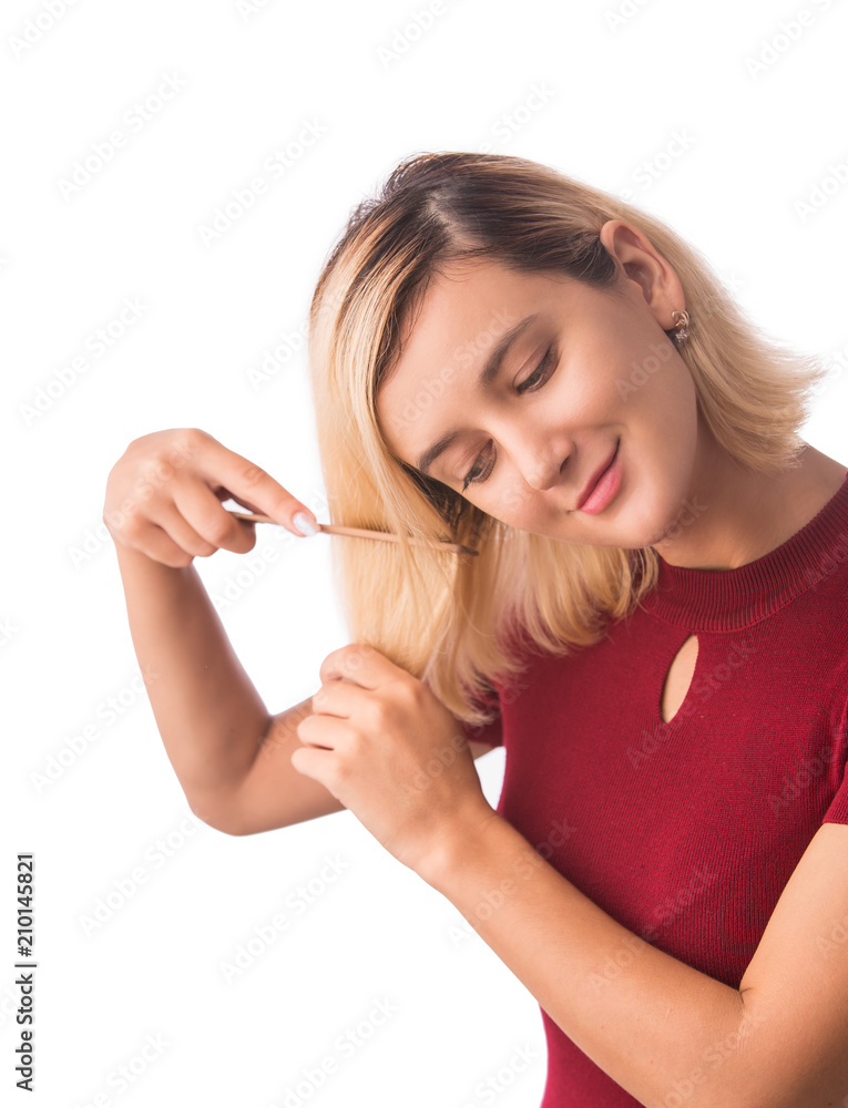 Beautiful young woman combing her hair. Isolated on white Beautiful young woman combing her hair. Isolated on white