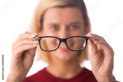 People and vision concept - young woman in glasses isolated on white
