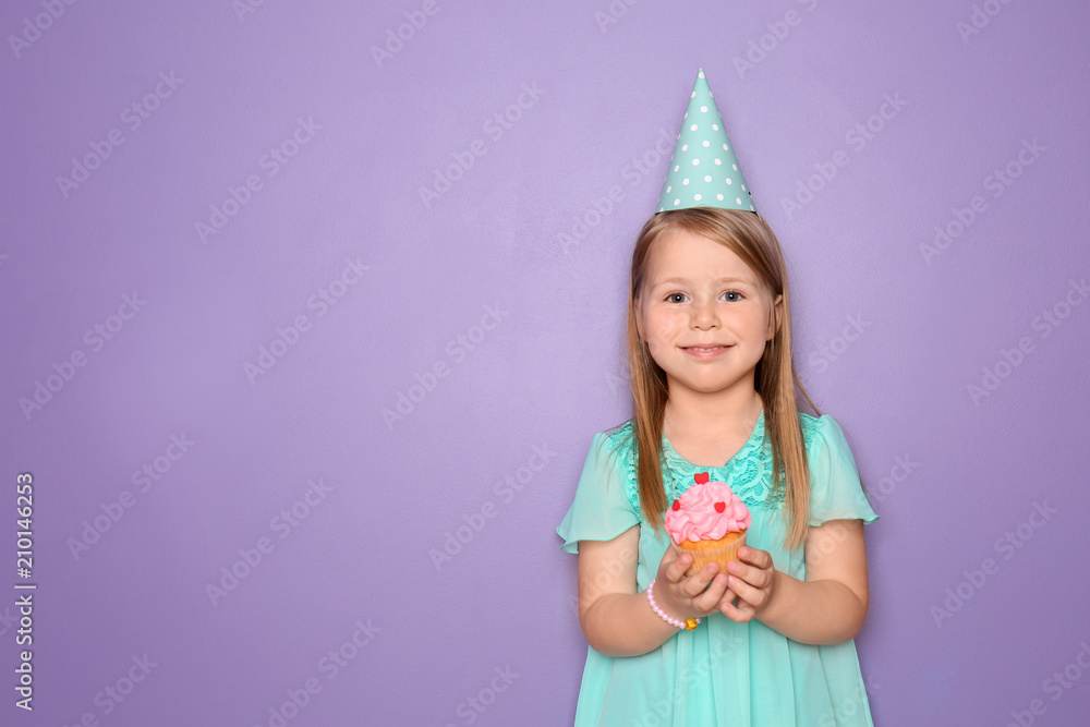 Cute little girl with birthday cupcake on color background Cute little girl with birthday cupcake on color background