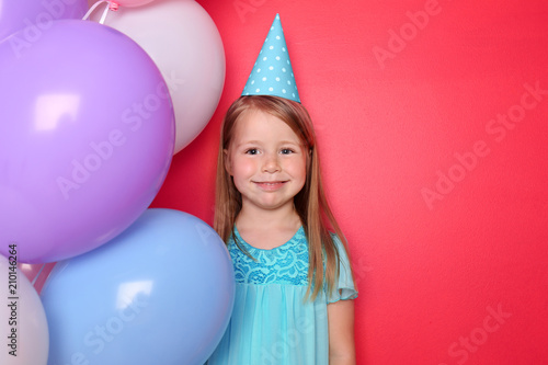 Cute little girl with ballo...