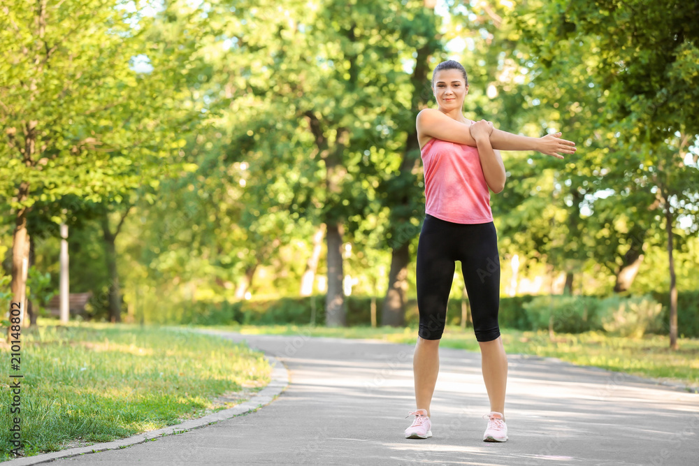 Sporty young woman training outdoors