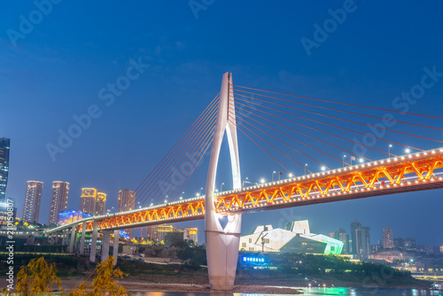 The qianshimen bridge at night is located in chongqing, China