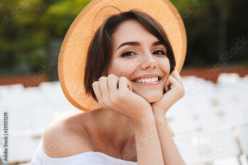 Close up of a smiling young girl in summer hat