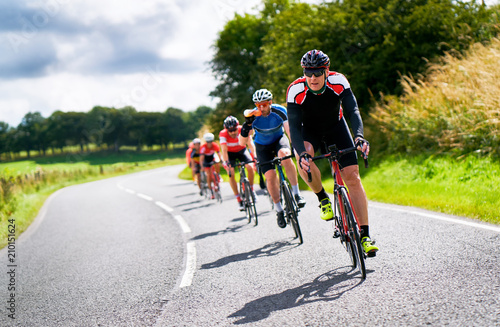 Fototapeta Naklejka Na Ścianę i Meble -  Cyclists racing on country roads on a sunny day in the UK.