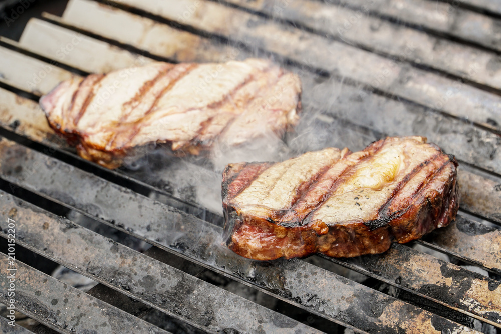 Grilled pork meet steak on a coal grill