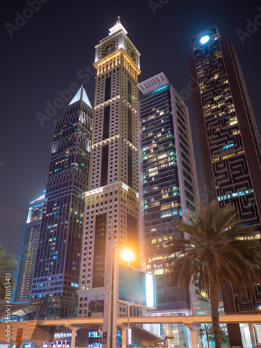 Night view of Dubai Downtown with skyscrapers.