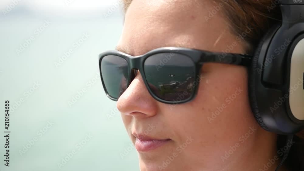 Young girl in headphones and sunglasses. close-up. slow motion, 1920x1080, full hd Young girl in headphones and sunglasses. close-up. slow motion, 1920x1080, full hd