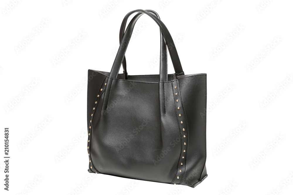 black female bag with handles, decorated with gold rivets, isolated on white background black female bag with handles, decorated with gold rivets, isolated on white background