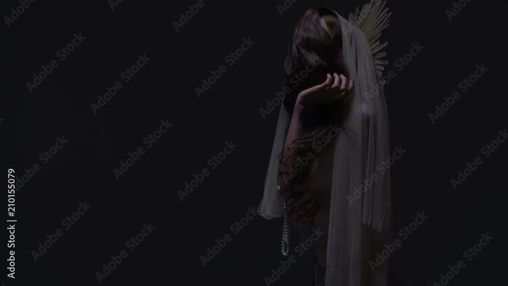 Woman with white face is embracing herself