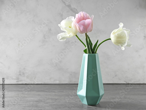 Vase with beautiful tulips on grey table © Pixel-Shot