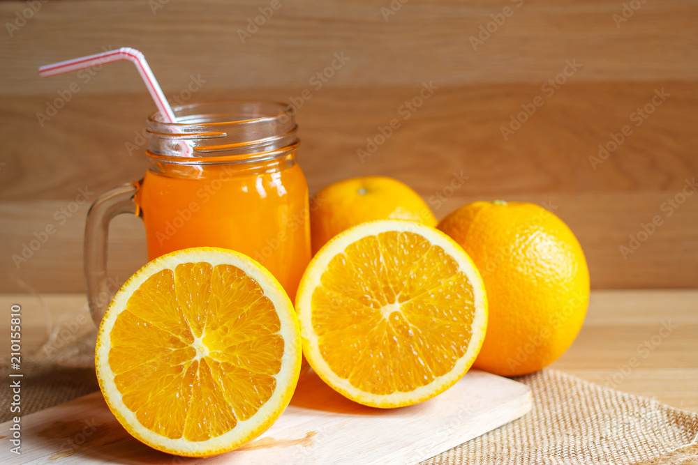 Orange and orange juice on wooden background Orange and orange juice on wooden background