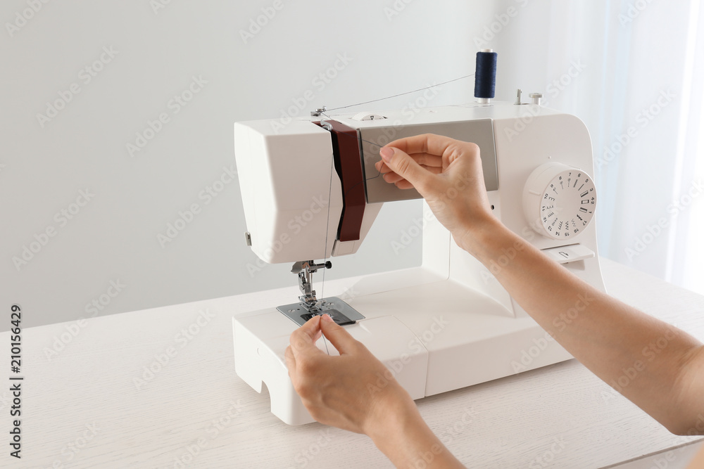 Female tailor threading sewing machine indoors Stock Photo Adobe Stock