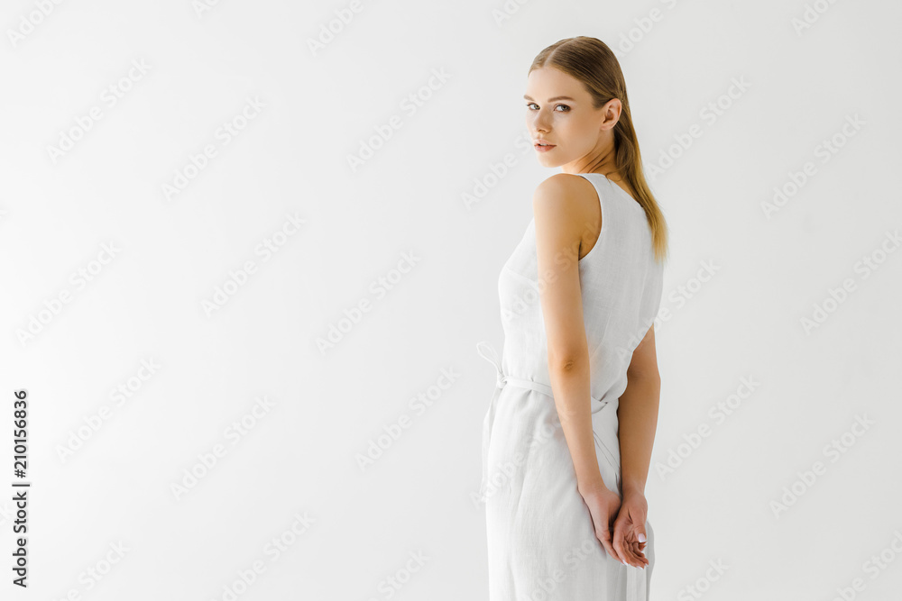 beautiful woman in linen white dress posing isolated on grey background beautiful woman in linen white dress posing isolated on grey background