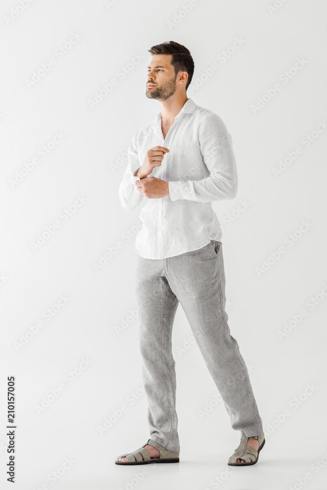 young man in linen clothes posing isolated on grey background young man in linen clothes posing isolated on grey background