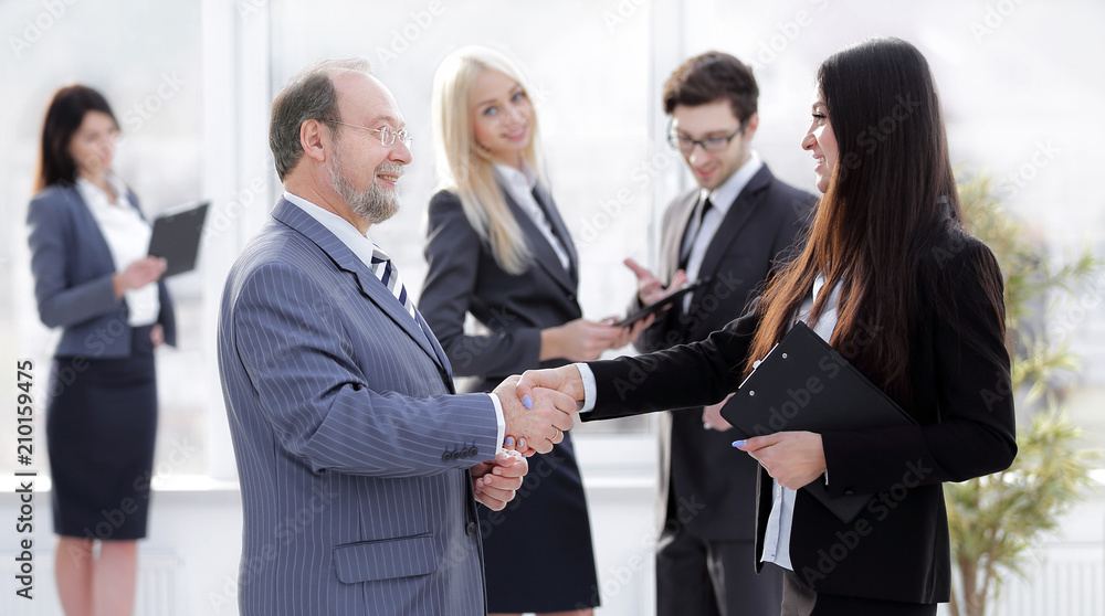 assistant meets a businessman with a handshake. meetings and partnership assistant meets a businessman with a handshake. meetings and partnership