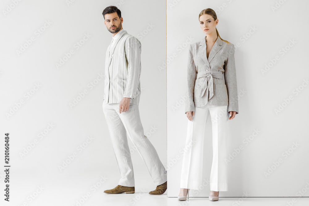 young male and female models in vintage clothes looking at camera on white - obrazy, fototapety, plakaty 
