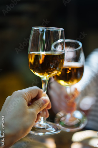 Glasses of white wine clanging together photo