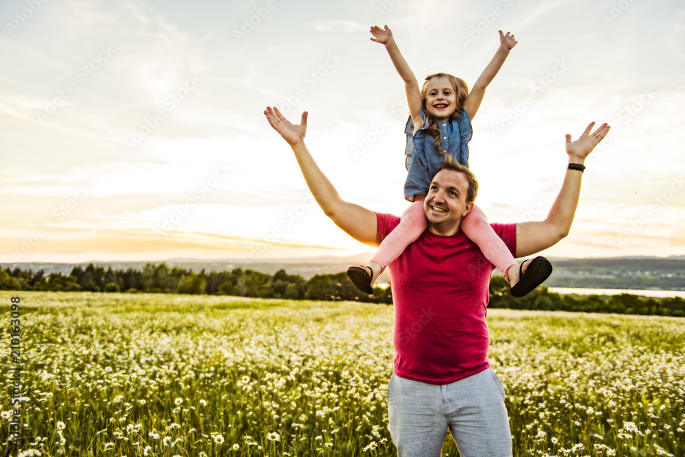 Father spending time with daughter during the sunset. Father spending time with daughter during the sunset.