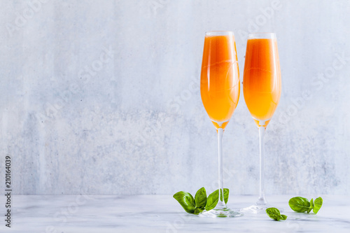 summer alcoholic fruit drink in glasses for champagne. on the marble table. with ice. refreshing cocktail