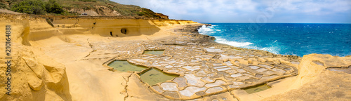 Fotografi Panoramic view of Salt evaporation ponds, also called salterns or salt pans located near Qbajjar on the maltese Island of Gozo
