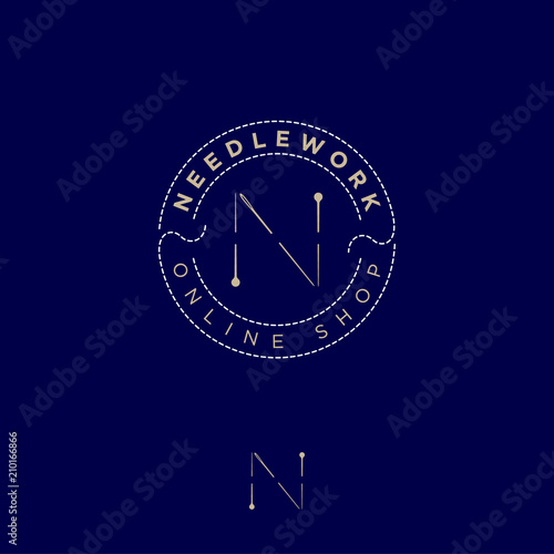 N letter consists of a pins and a needle in a thread circle. Handicraft and tailoring. Online shop for sewing and needlework.