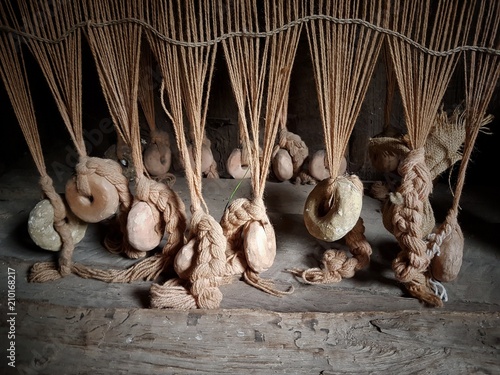 Bilde på lerret Lines of clay loom weights keep the threads taught on an replica Anglo-Saxon loom