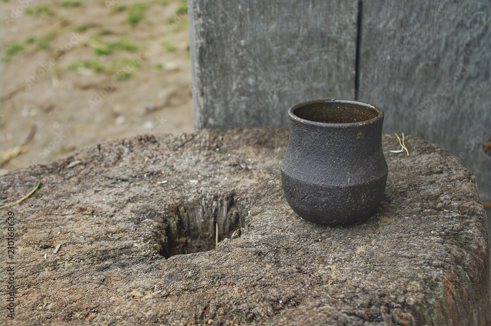 A Saxon / Viking style pottery cup on a tree stump. A Saxon / Viking style pottery cup on a tree stump.