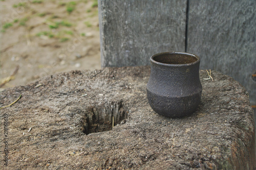 A Saxon   Viking style pottery cup on a tree stump.
