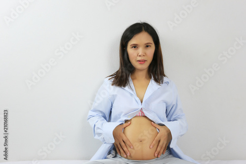 Asian pregnant mother in blue dress to Photography of baby in stomach lovely portrait.