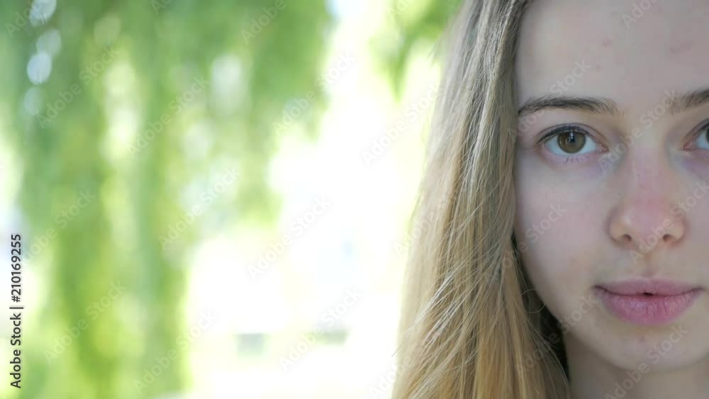 closeup portrait of beautiful girl looking at camera. Half her face closeup portrait of beautiful girl looking at camera. Half her face