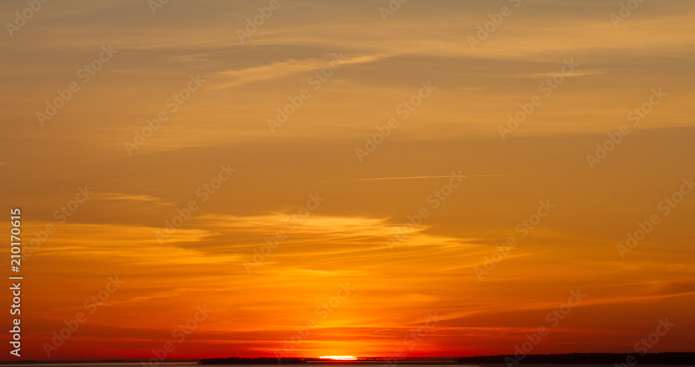 Beautiful sunset over the sea. The concept of a colorful sky: at sunset with a twilight colored sky. Bright sunset over the horizon