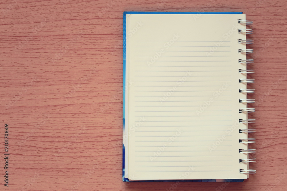 Empty book is placed on a brown wooden background. Empty book is placed on a brown wooden background.