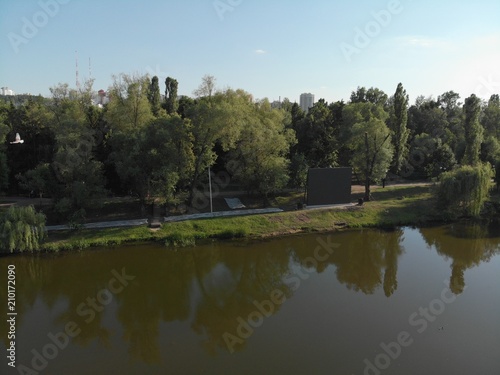 flight over the river in a city park among trees © virythtpehjljd89