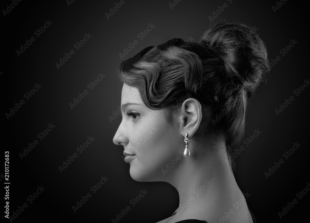 Portrait of a beautiful woman with perfect hair and  pearl earrings .