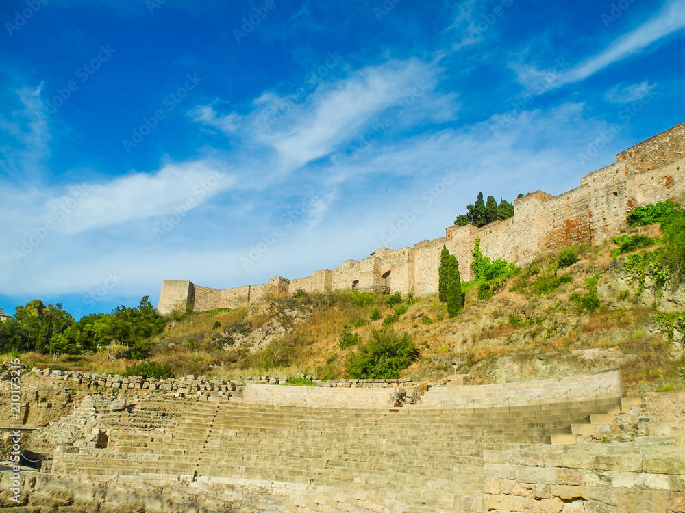 Alcazaba, the fortress palace and citadel with ruins of roman theatre in Malaga, Spain. Beautiful blue summer sky.